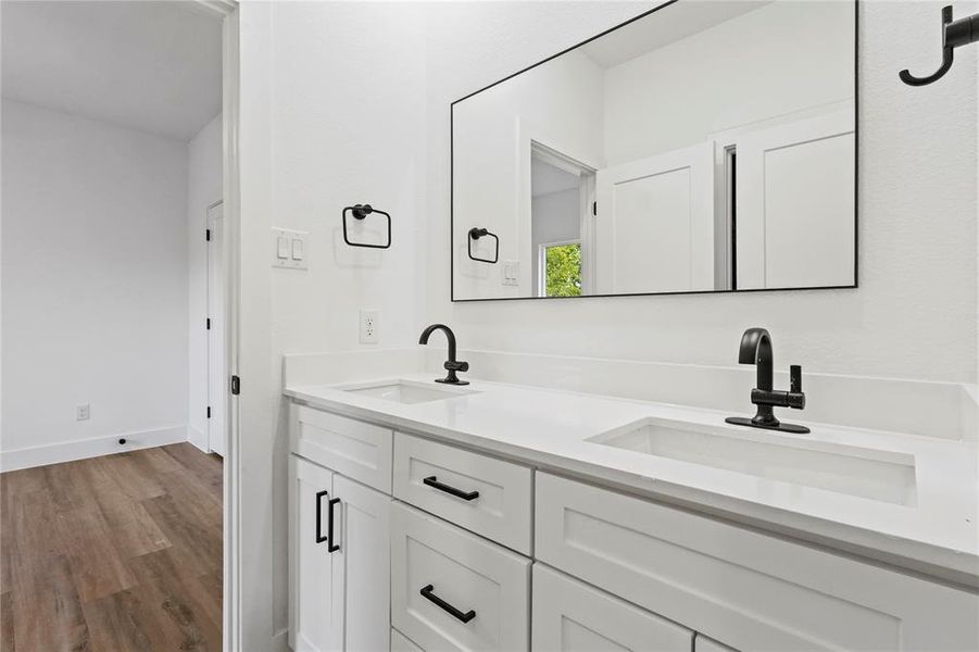 Bathroom with light wood-type flooring and double vanity