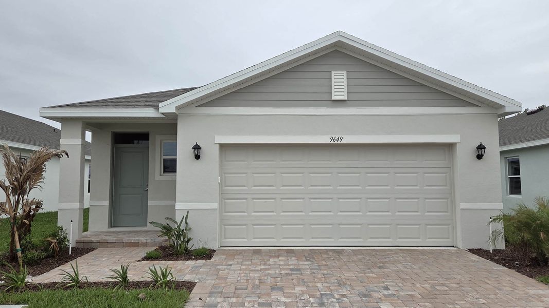 Front exterior of a new home in Venetian Grove, Vero Beach, FL, highlighting curb appeal (Image 1). Front exterior of a new home in Venetian Grove, Vero Beach, FL, highlighting curb appeal (Image 1).