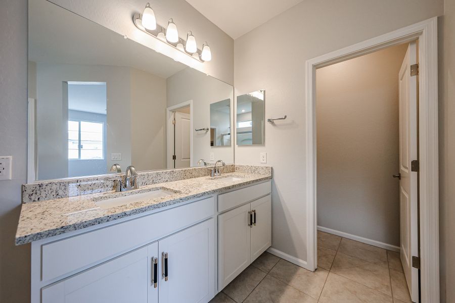 A bathroom with a marble countertop.