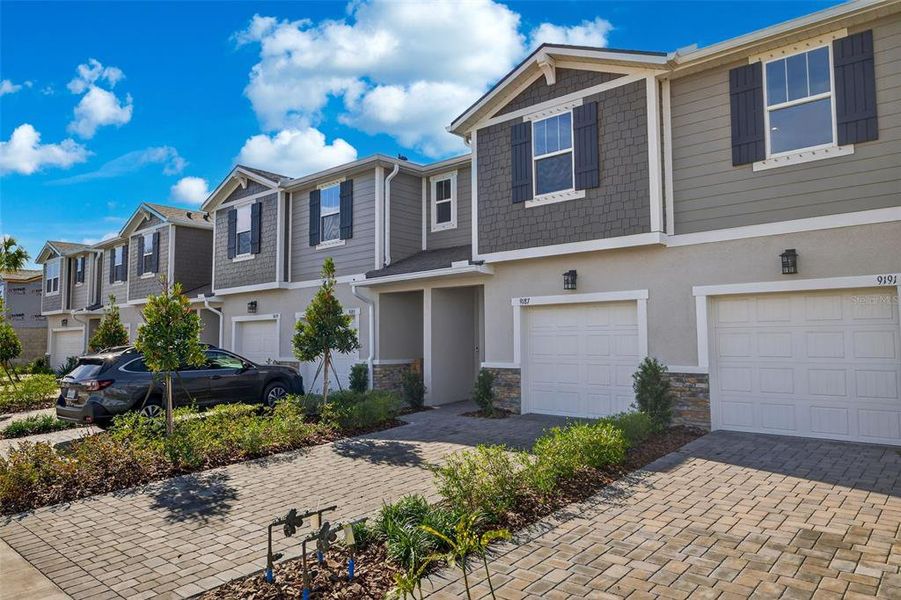 Front exterior of a new home in Crosswind Ranch, Parrish, FL, highlighting curb appeal (Image 21).
