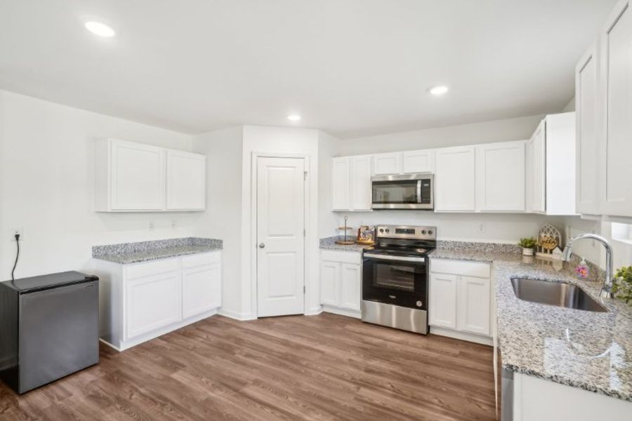 A kitchen with white cabinets. A kitchen with white cabinets.