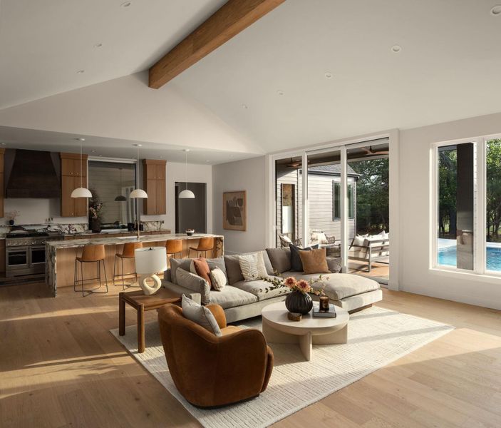 An open concept living area transitions effortlessly from the gourmet kitchen to outdoor recreation with a poolside view. An open concept living area transitions effortlessly from the gourmet kitchen to outdoor recreation with a poolside view.