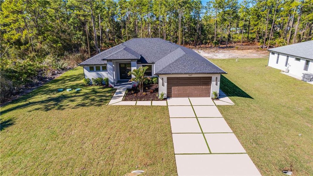 Front exterior of a new home in , Lehigh Acres, FL, highlighting curb appeal (Image 30). Front exterior of a new home in , Lehigh Acres, FL, highlighting curb appeal (Image 30).