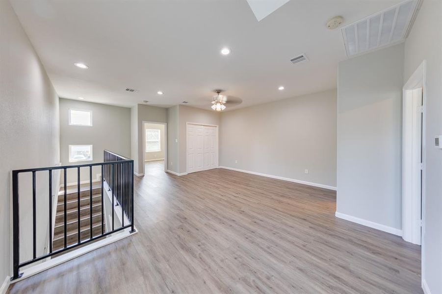 On the second floor, you’re welcomed by a fantastic game room that could easily serve as a spacious living area. With ceiling lights in every large section, this room is bright and inviting, ensuring every corner is well-lit at any time of day.