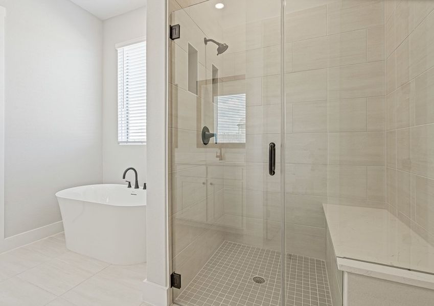 The master bathroom has a glass, walk-in shower and a stand alone tub.