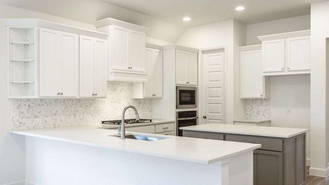 Kitchen with open shelves, a peninsula, stainless steel oven, white cabinets, and recessed lighting Kitchen with open shelves, a peninsula, stainless steel oven, white cabinets, and recessed lighting