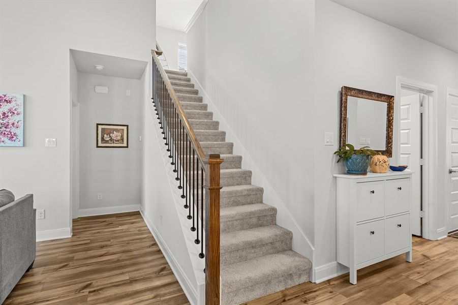 Staircase featuring wood finished floors and baseboards Staircase featuring wood finished floors and baseboards