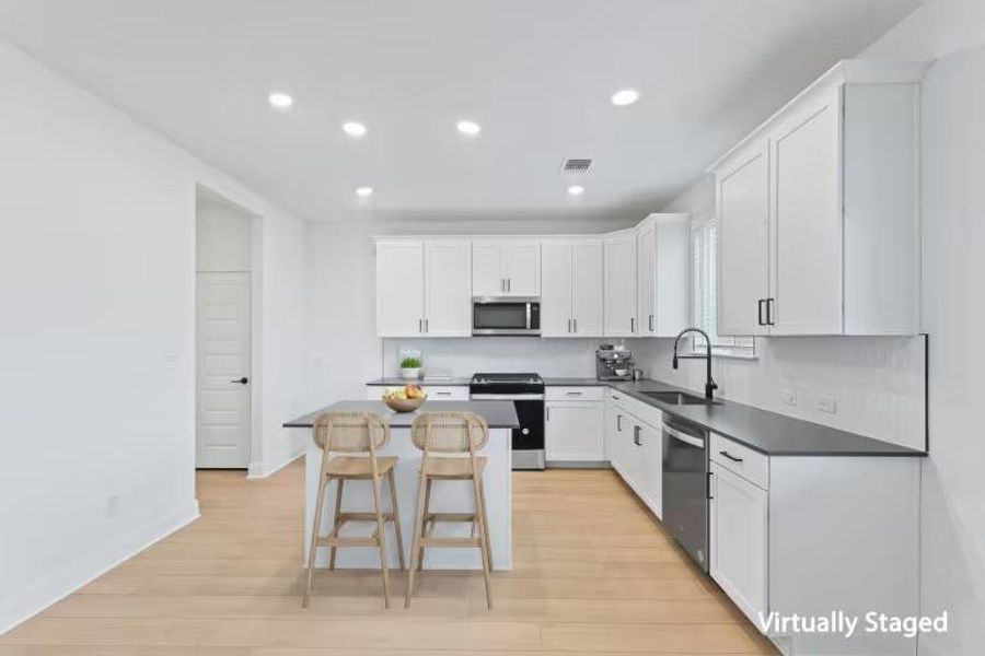 Photo of Pulte model home with same floor plan, not of actual home listed.