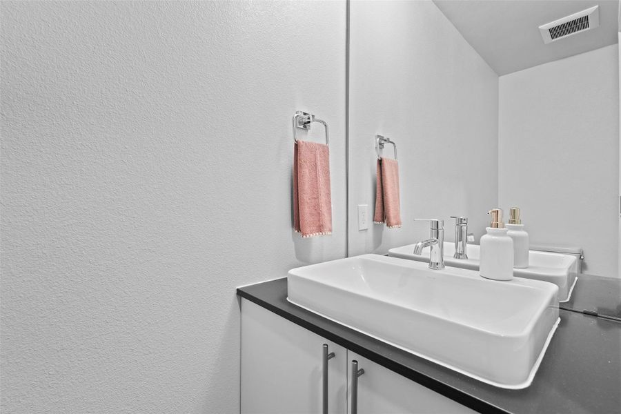 Bathroom featuring a sink and visible vents