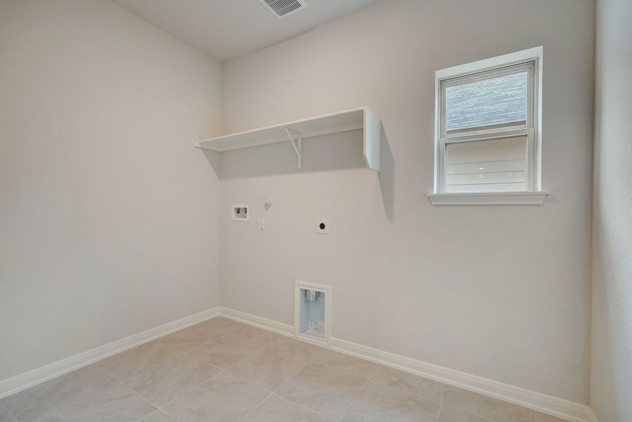 Laundry room in the Pearl floorplan at a Meritage Homes community.