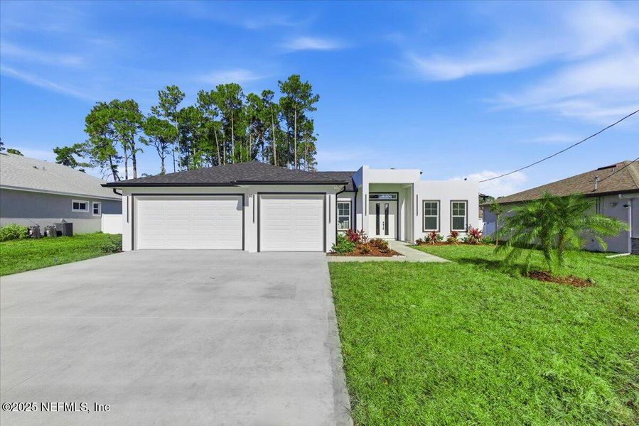 Front exterior of a new home in , Palm Coast, FL, highlighting curb appeal (Image 1). Front exterior of a new home in , Palm Coast, FL, highlighting curb appeal (Image 1).