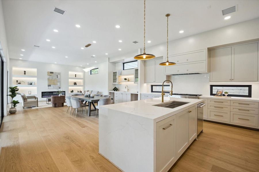 Sleek chef’s kitchen with quartz island, high-end custom cabinetry, and designer pendant lighting. Sleek chef’s kitchen with quartz island, high-end custom cabinetry, and designer pendant lighting.