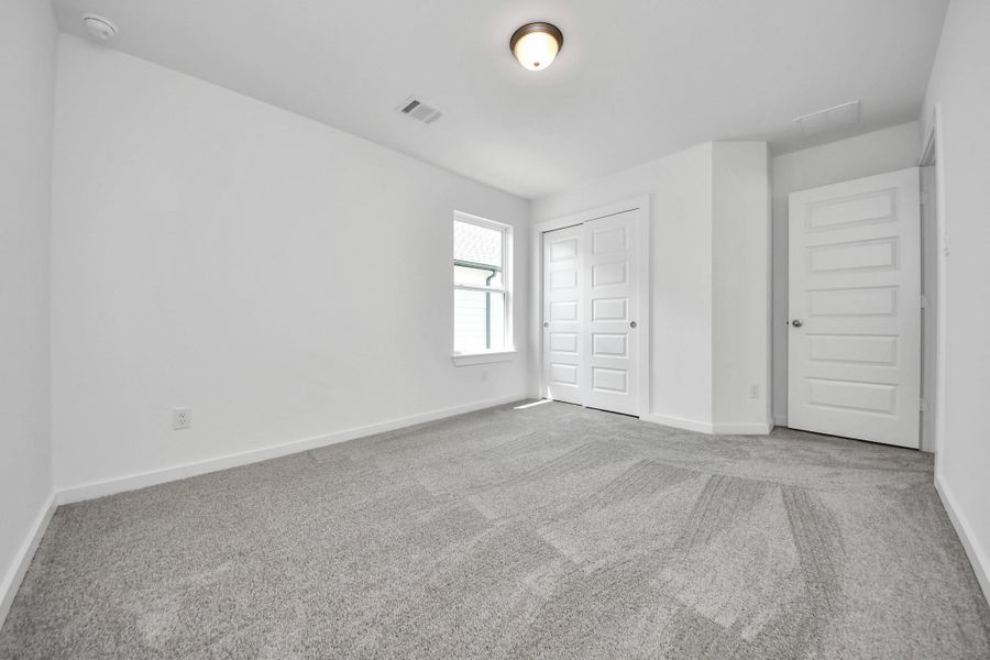 Generously sized secondary bedrooms featuring spacious closets, soft and inviting carpeting underfoot, large windows allowing plenty of natural light, and the added touch of privacy blinds for your personal retreat. Sample photo of completed home with similar floor plan. Actual colors and selections may vary.