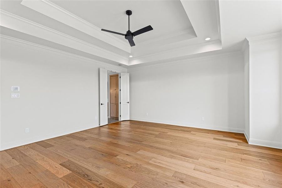 Spare room with ceiling fan, light wood-style flooring, ornamental molding, and recessed lighting