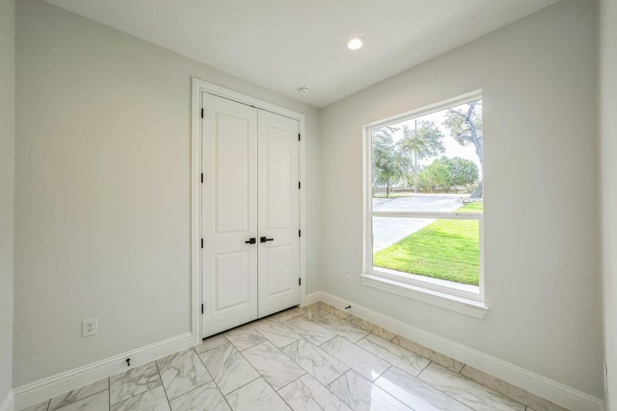Unfurnished bedroom with light marble finish flooring, a closet, and recessed lighting