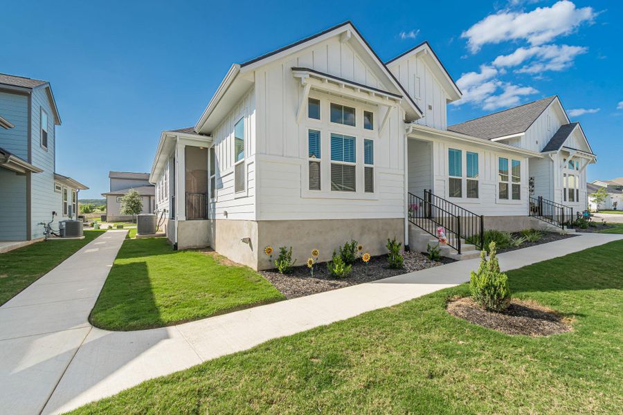 Crisp white siding adorns this charming residence, framed by vibrant green lawns and a welcoming pathway. Crisp white siding adorns this charming residence, framed by vibrant green lawns and a welcoming pathway.