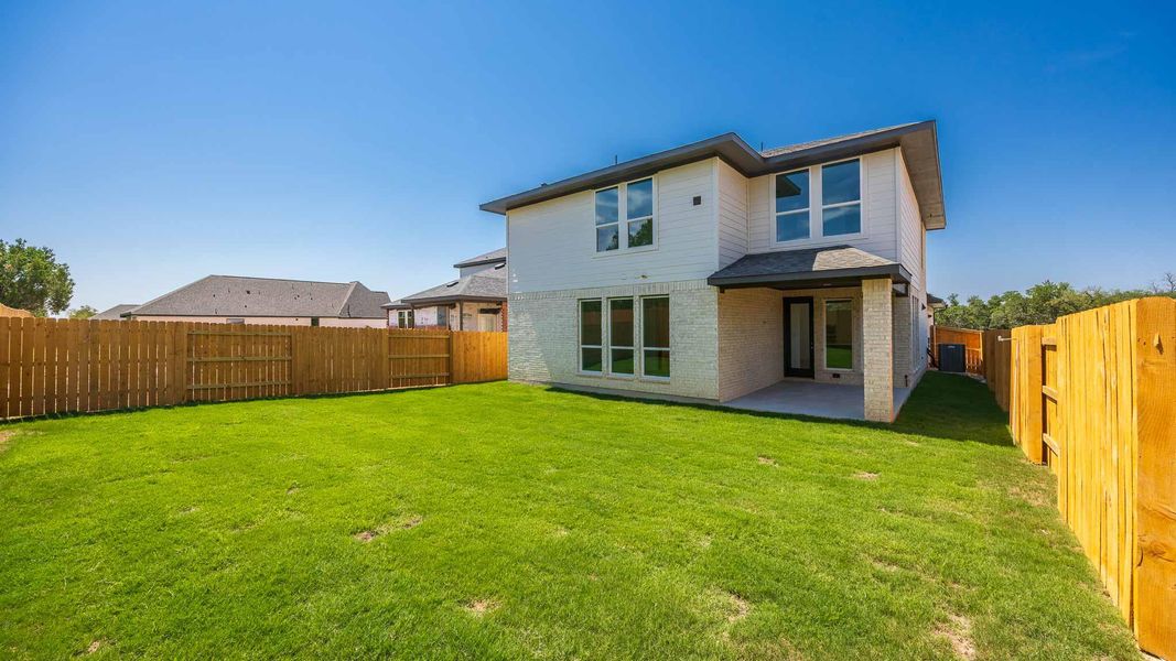 Back of house featuring a patio area, brick siding, and a fenced backyard Back of house featuring a patio area, brick siding, and a fenced backyard