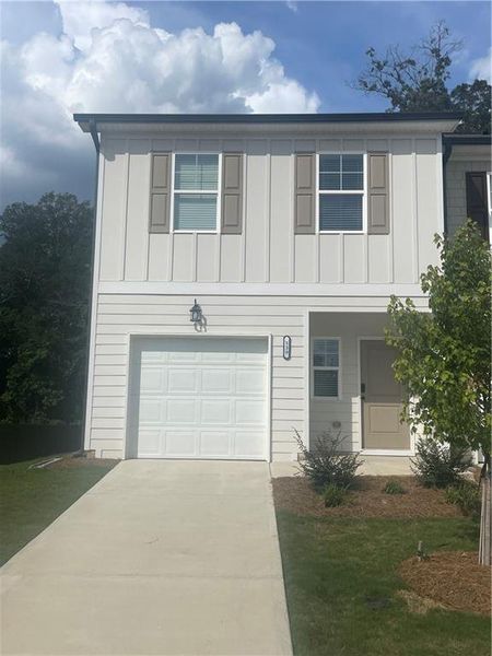 Front exterior of a new home in Cambridge at Towne Center, Hoschton, GA, highlighting curb appeal (Image 1).