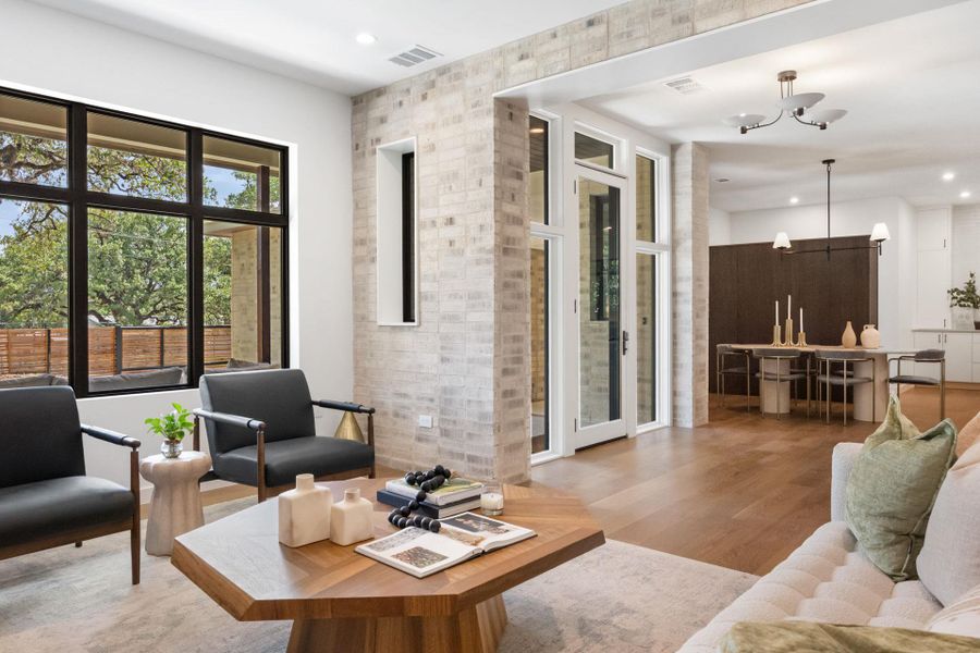 Living area with light wood-style floors, a chandelier, and recessed lighting