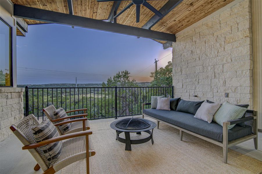 Patio terrace at dusk with an outdoor living space with a fire pit Patio terrace at dusk with an outdoor living space with a fire pit