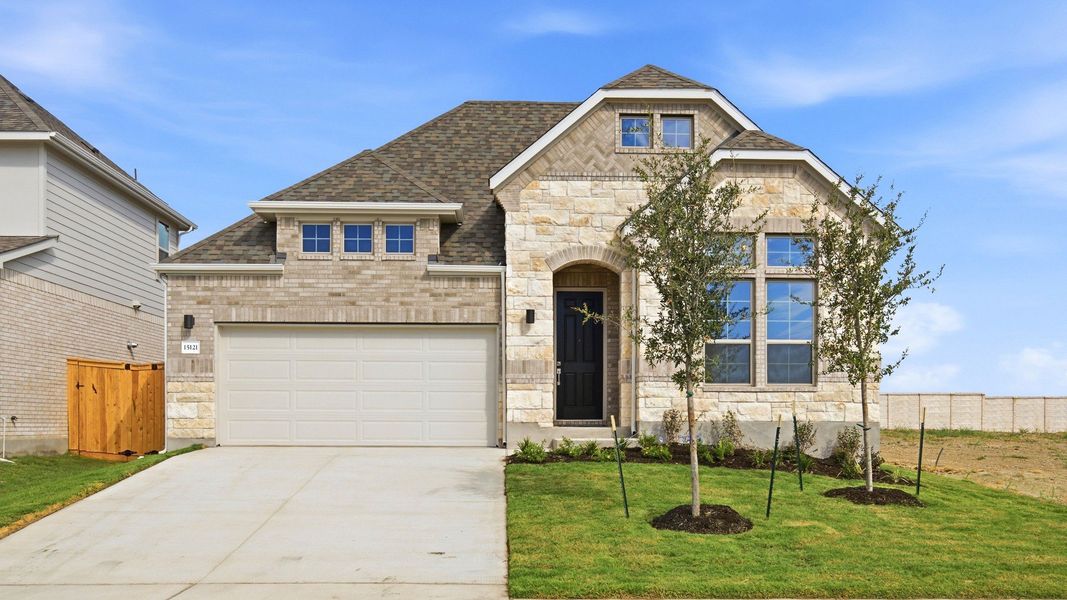 Front exterior of a new home in Newhaven, Manor, TX, highlighting curb appeal (Image 2). Front exterior of a new home in Newhaven, Manor, TX, highlighting curb appeal (Image 2).