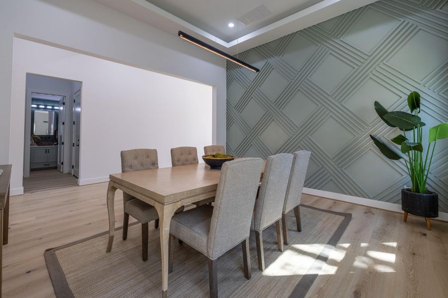 Dedicated dining area with custom accent wall and refined finishes that elevate the entertaining experience.