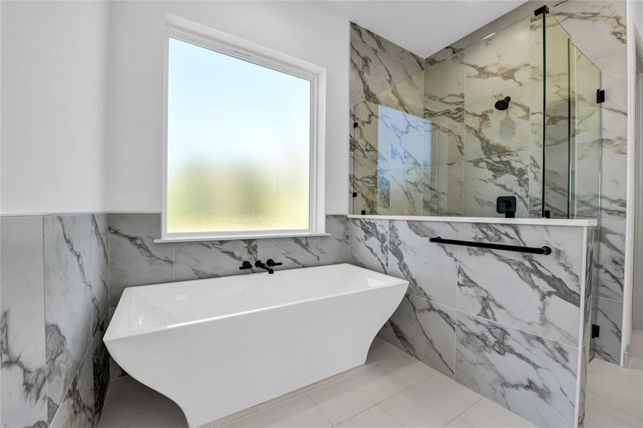 Bathroom with tile walls, plus walk in shower, and tile patterned floors