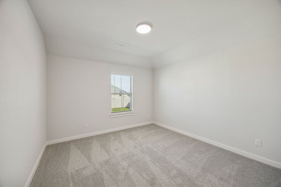 Bedroom in the Wimbledon home plan by Trophy Signature Homes – REPRESENTATIVE PHOTO