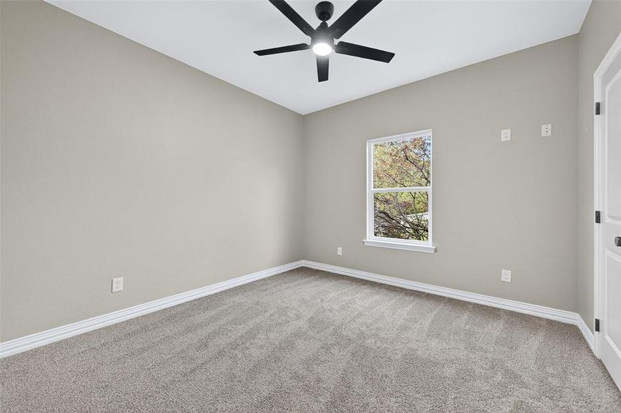 Spare room with light carpet and a ceiling fan Spare room with light carpet and a ceiling fan