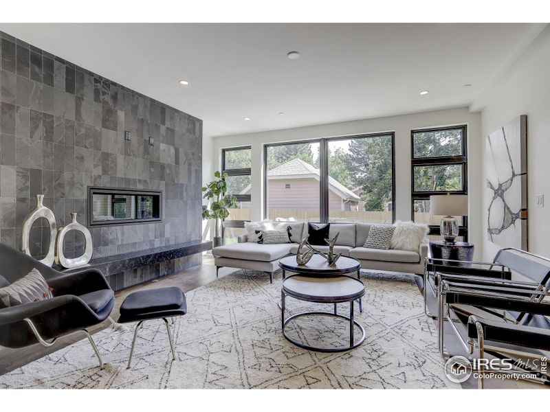 Open living spaces with "Tobacco Pipe" wood floors and with accents of Slate tile and Soapstone floating bench