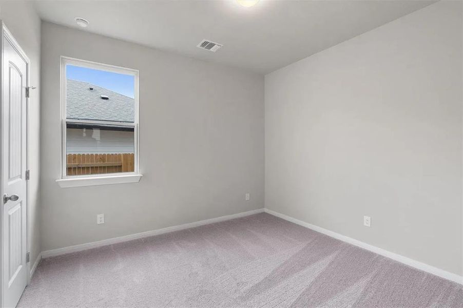 A well-lit bedroom offering a blank canvas for personalization.