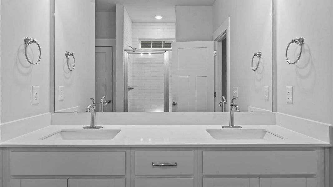 Highly functional and elegant en-suite with dual vanities, tiled walk-in shower, and refined finishes Highly functional and elegant en-suite with dual vanities, tiled walk-in shower, and refined finishes