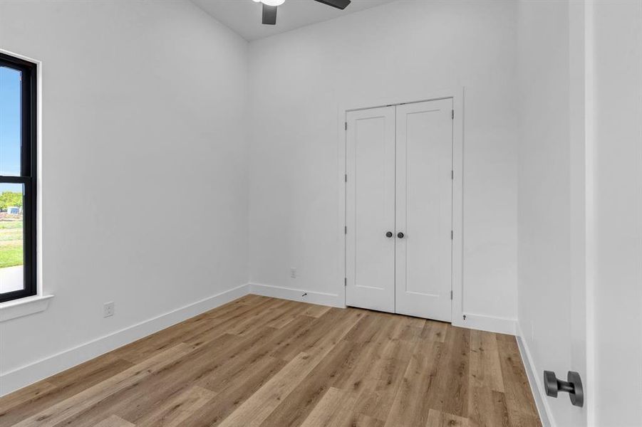 Bedroom featuring light wood-type flooring and ceiling fan