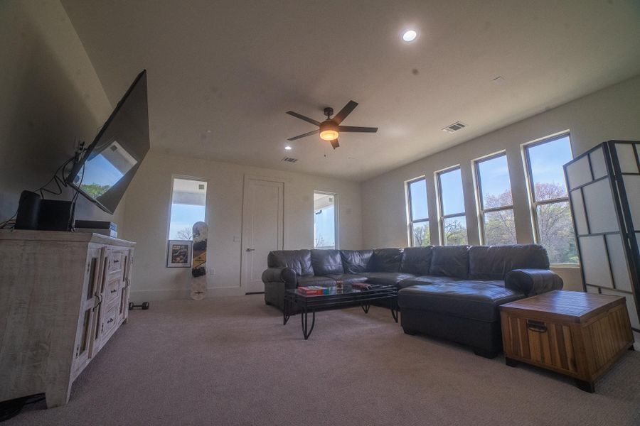 The ultimate entertainment hub awaits in this expansive game room, where the fun extends outdoors. Step out onto the private balcony to enjoy a breath of fresh air between rounds of pool or to take in the sunset after a movie marathon, creating a seamless flow for hosting unforgettable gatherings