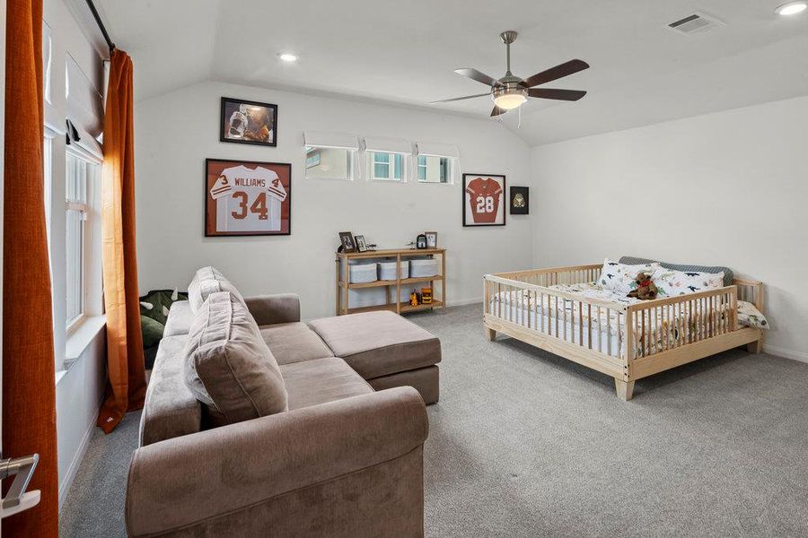 Carpeted bedroom featuring visible vents, baseboards, vaulted ceiling, recessed lighting, and a ceiling fan