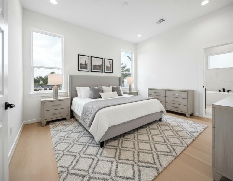 Spacious primary bedroom in Thornton Oaks featuring bright, natural light from oversized windows and contemporary light-toned wood flooring. This airy suite offers a minimalist design with crisp white walls and recessed lighting, creating a perfect retreat in this new construction community near Oak Forest and The Heights. *Virtually staged*
