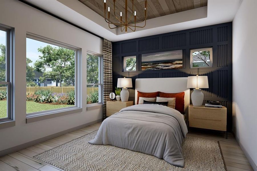Bedroom featuring suspended lighting, light wood finished floors, an accent wall, and a wood tray ceiling