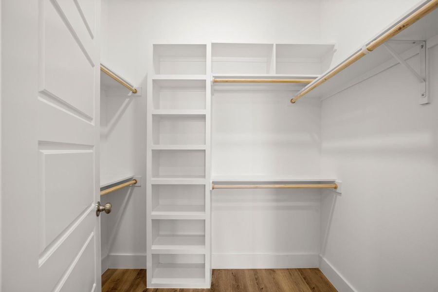 Ample storage solutions await in this well-organized closet, featuring built-in shelving and hanging rods. Ample storage solutions await in this well-organized closet, featuring built-in shelving and hanging rods.