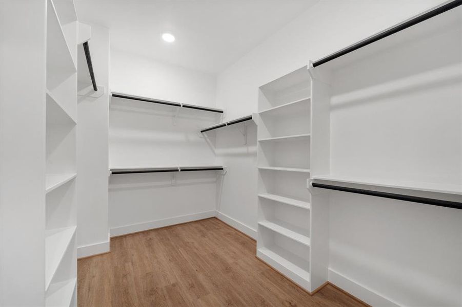 Be captivated by the primary rooms' large walk-in closet! Has custom shelves for extra storage and the vinyl flooring continues throughout.