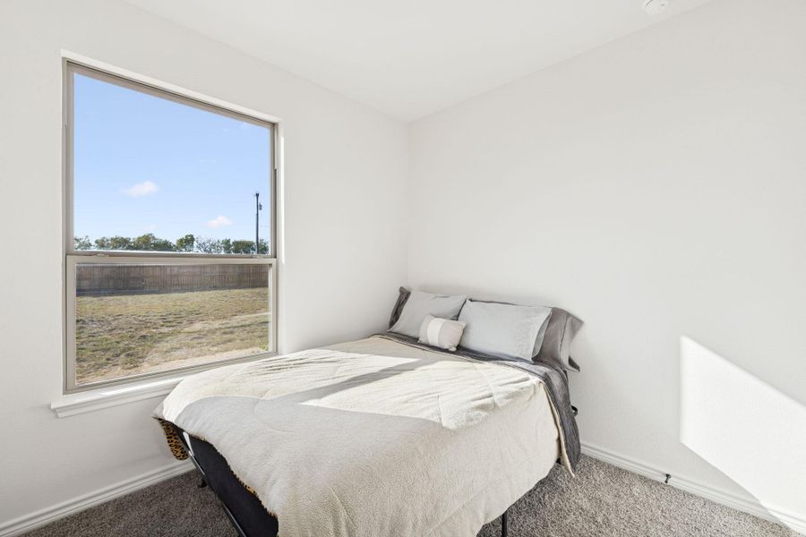 Bedroom featuring carpet flooring and baseboards Bedroom featuring carpet flooring and baseboards