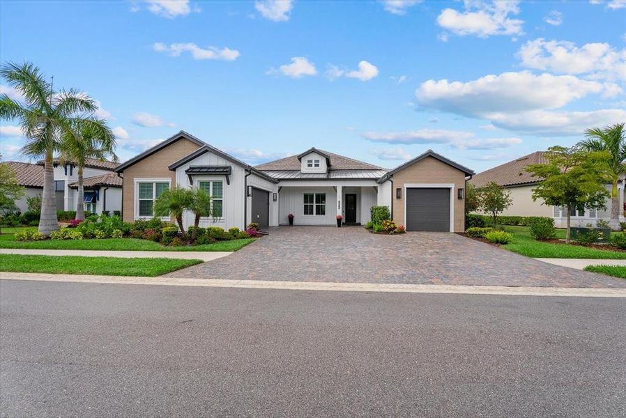 Front exterior of a new home in Gran Place, Venice, FL, highlighting curb appeal (Image 22).