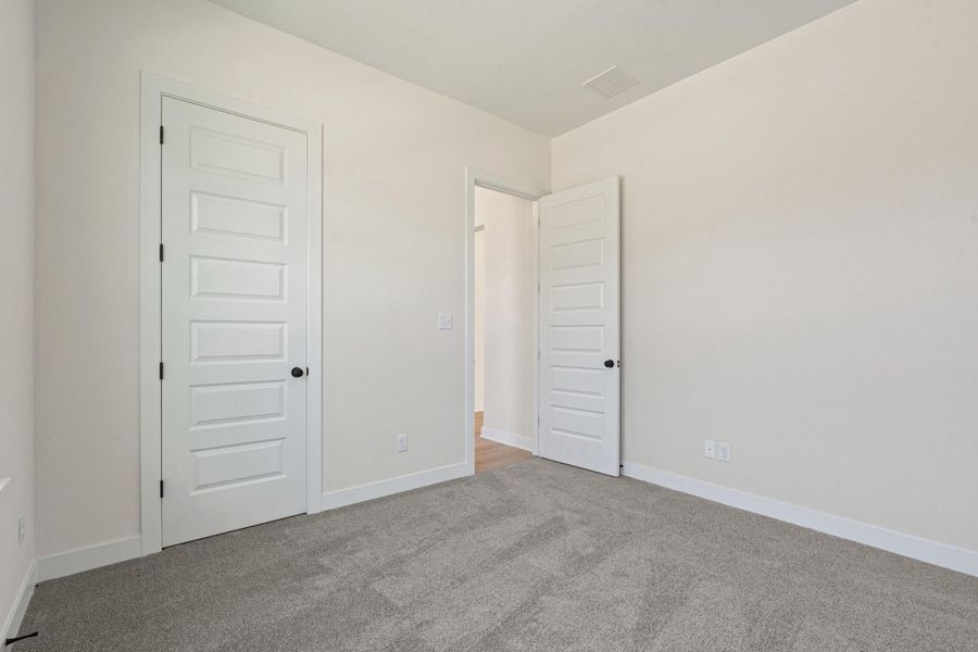 Unfurnished bedroom featuring carpet floors and a closet