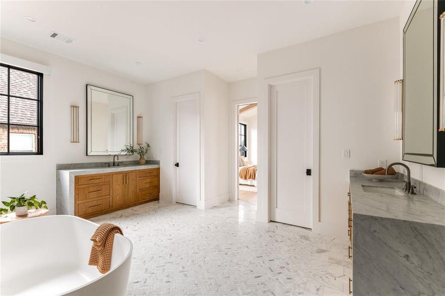 Full bathroom with vanity and a freestanding tub