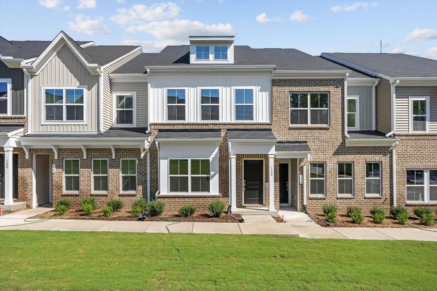 Front exterior of a new home in Renaissance at White Oak, Garner, NC, highlighting curb appeal (Image 1). Front exterior of a new home in Renaissance at White Oak, Garner, NC, highlighting curb appeal (Image 1).