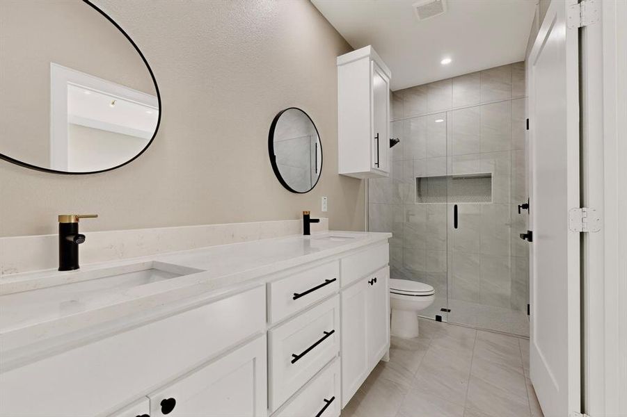 Full bath with double vanity, a stall shower, recessed lighting, and light tile patterned floors Full bath with double vanity, a stall shower, recessed lighting, and light tile patterned floors