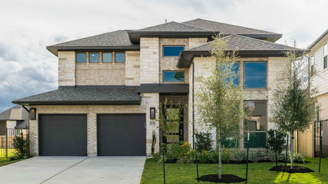 Front exterior of a new home in Santa Rita Ranch 50', Liberty Hill, TX, highlighting curb appeal (Image 11). Front exterior of a new home in Santa Rita Ranch 50', Liberty Hill, TX, highlighting curb appeal (Image 11).