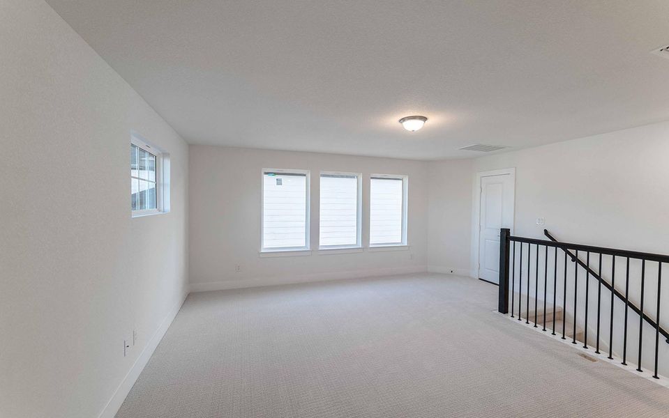 Carpeted empty room featuring plenty of natural light