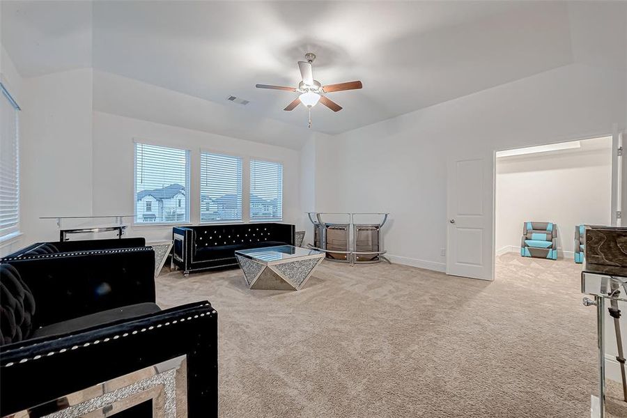 Upstairs Game Room: Spacious with a wall of windows, access to balcony and an extra closet.