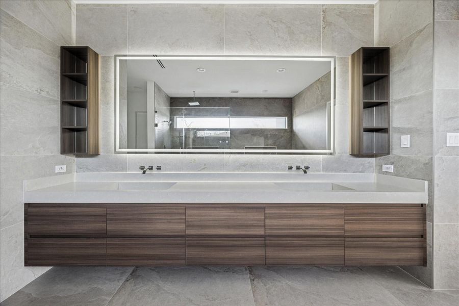 Dual vanities, ample storage space and a light up mirror.