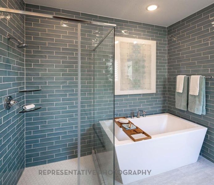 Full bathroom with tile walls, a shower stall, a soaking tub, and recessed lighting Full bathroom with tile walls, a shower stall, a soaking tub, and recessed lighting